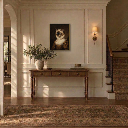 Aristocrat ragdoll cat portrait hanging above a console table in an entryway