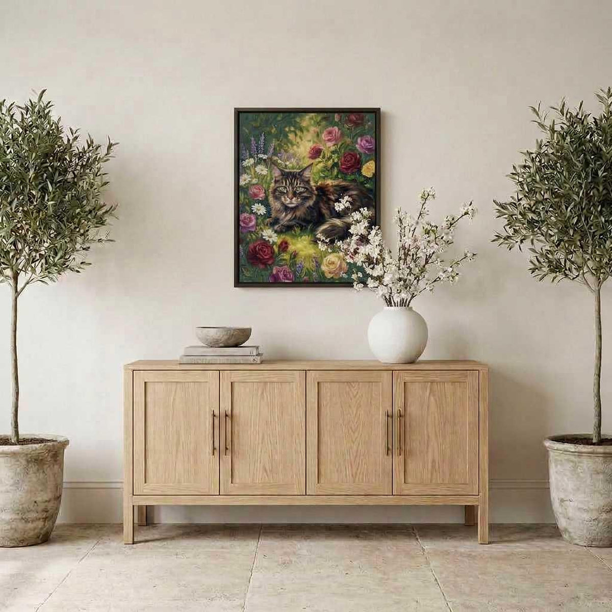 Meadow Bloom Maine Coon portrait hanging above a sideboard between potted olive trees