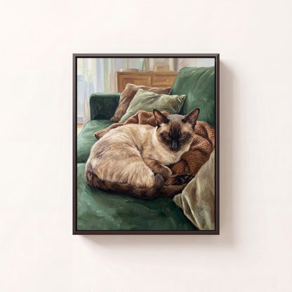 Cozy at Home oil portrait of a Siamese cat curled on a green sofa, black frame on a white wall