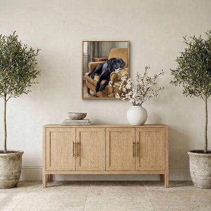 Cozy at Home black Labrador portrait hanging above a sideboard between potted olive trees